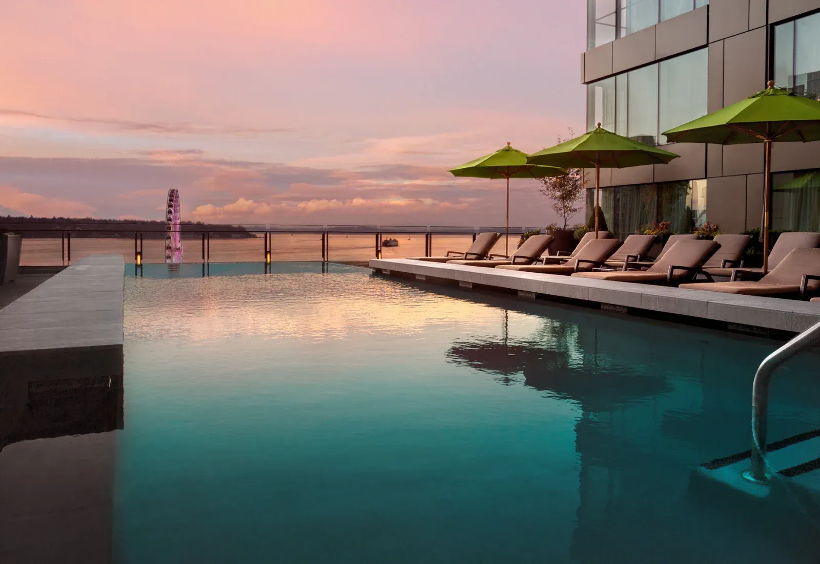 Four Seasons Seattle's rooftop infinity pool overlooking Elliott Bay and the Olympic Mountains.