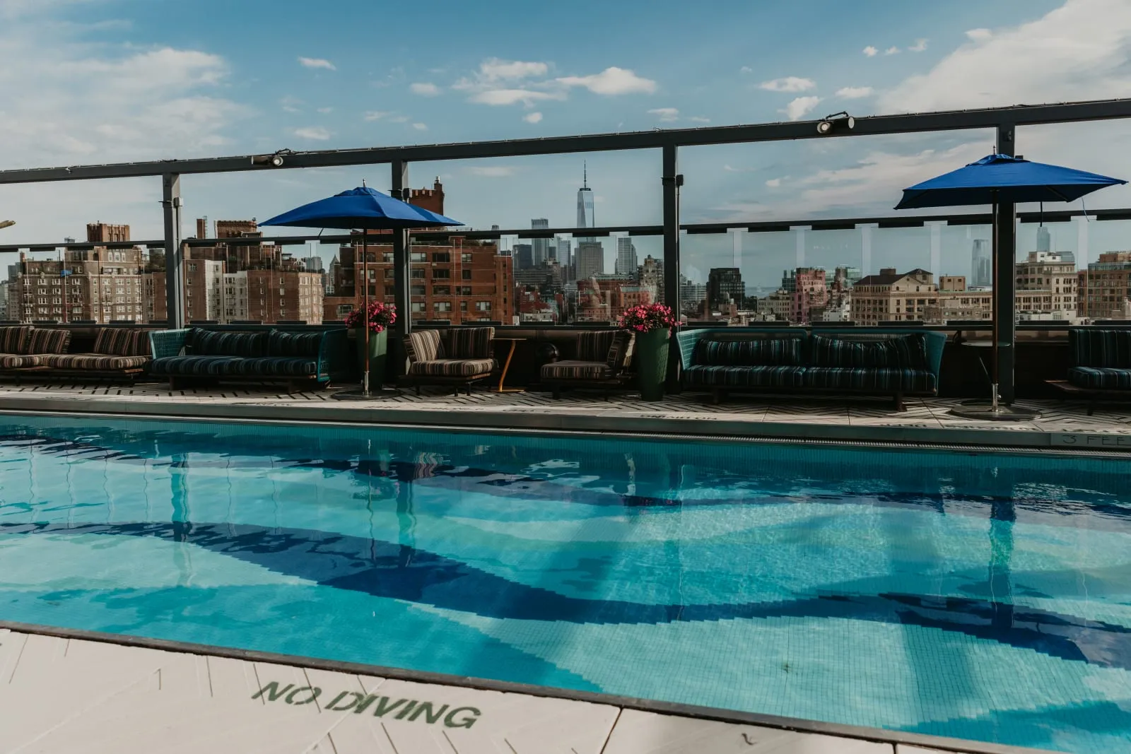 Gansevoort Meatpacking's rooftop pool with the Manhattan skyline and Hudson beyond.
